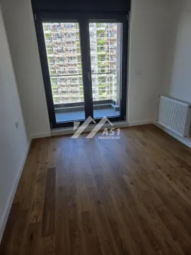 Empty room with wooden flooring and access to the balcony. - image 5