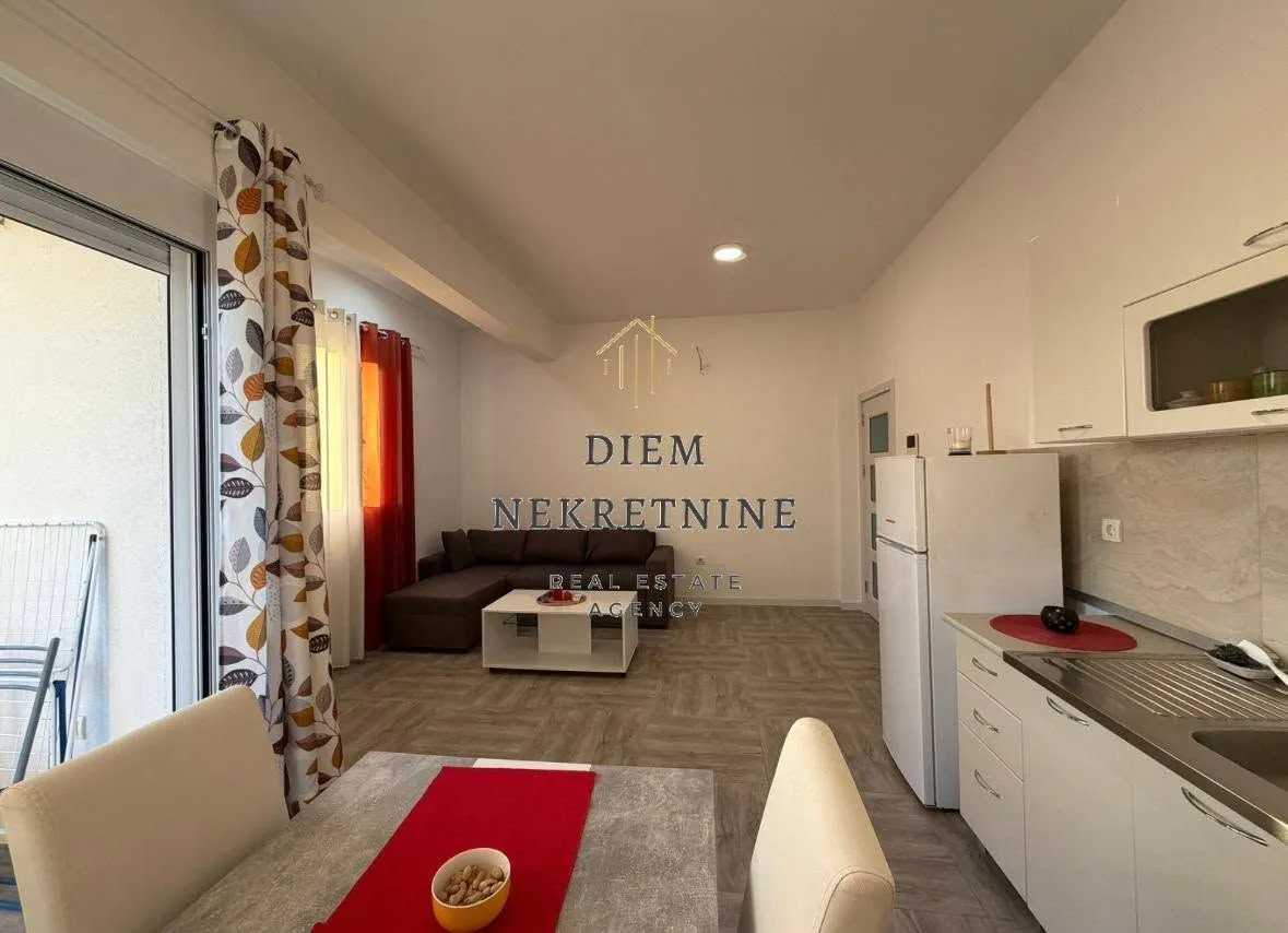 Small kitchen with a dining table and a view of the living room.