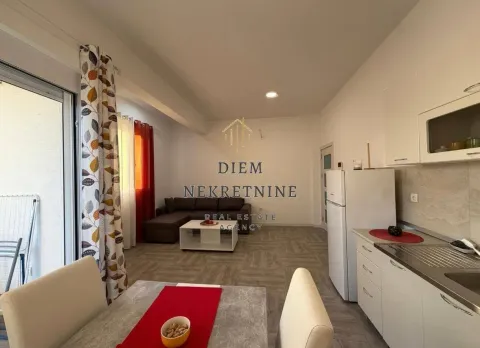 Small kitchen with a dining table and a view of the living room. - image 11