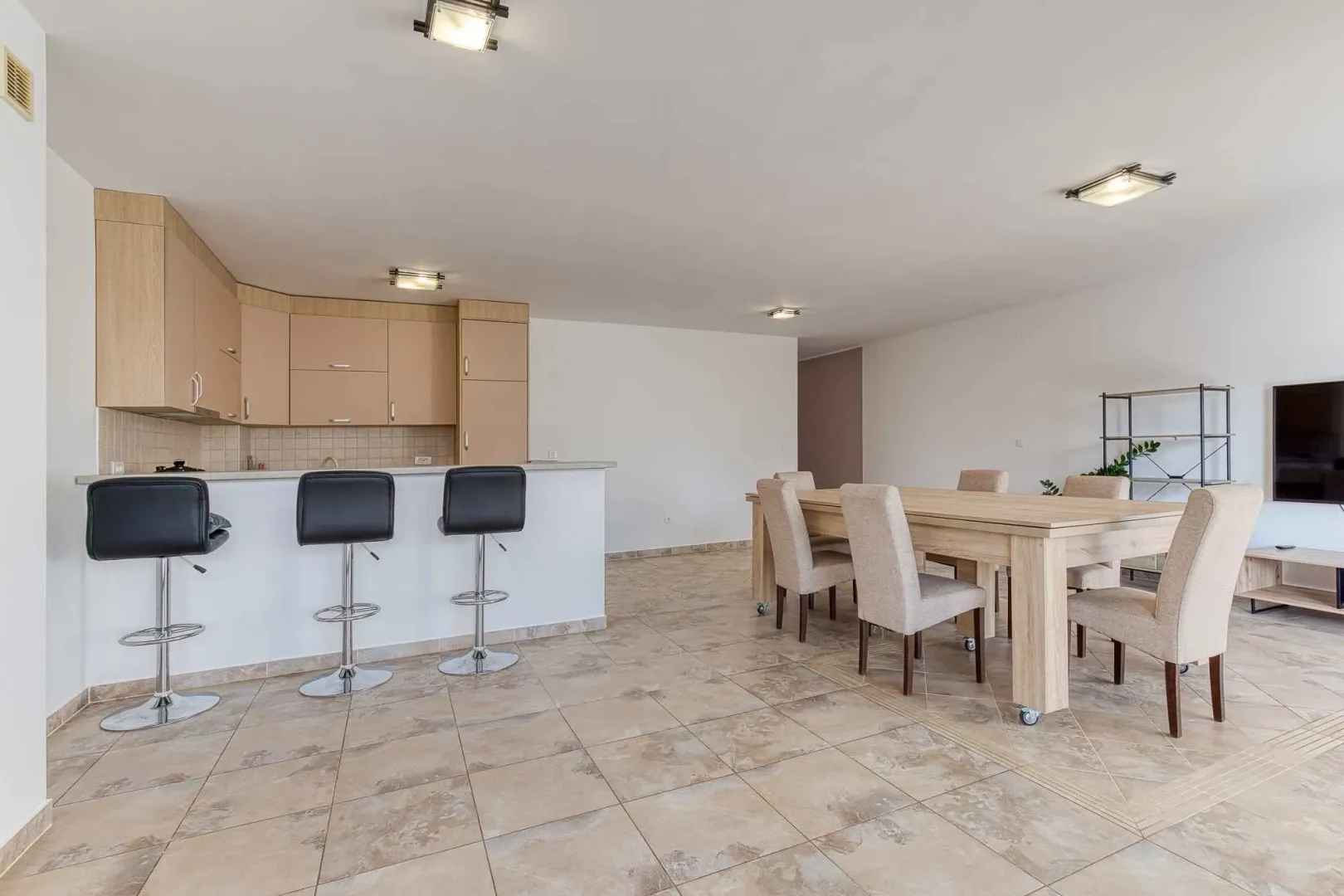 Open plan space featuring a kitchen, breakfast bar, and dining area.