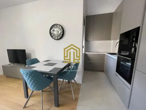 Modern kitchen with dining area and built-in appliances. - image 3