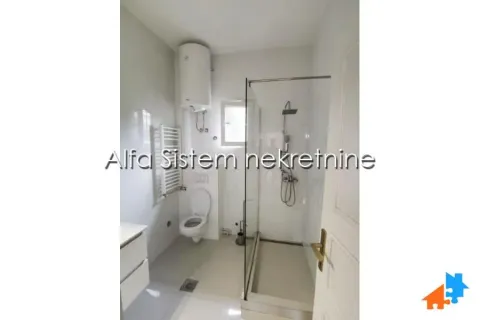 Modernly equipped bathroom with a walk-in shower and toilet. - image 18