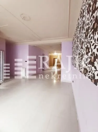 Empty spacious room with light walls and decorative wallpaper.