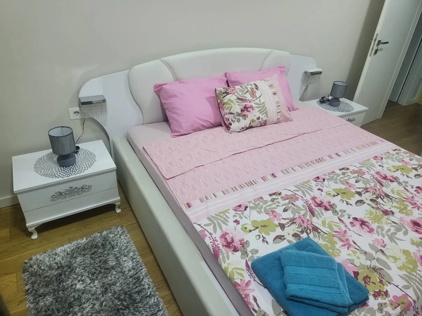 Bright bedroom with a double bed and nightstands.
