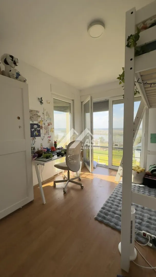 Children's bedroom with a bunk bed, desk, and access to the terrace.