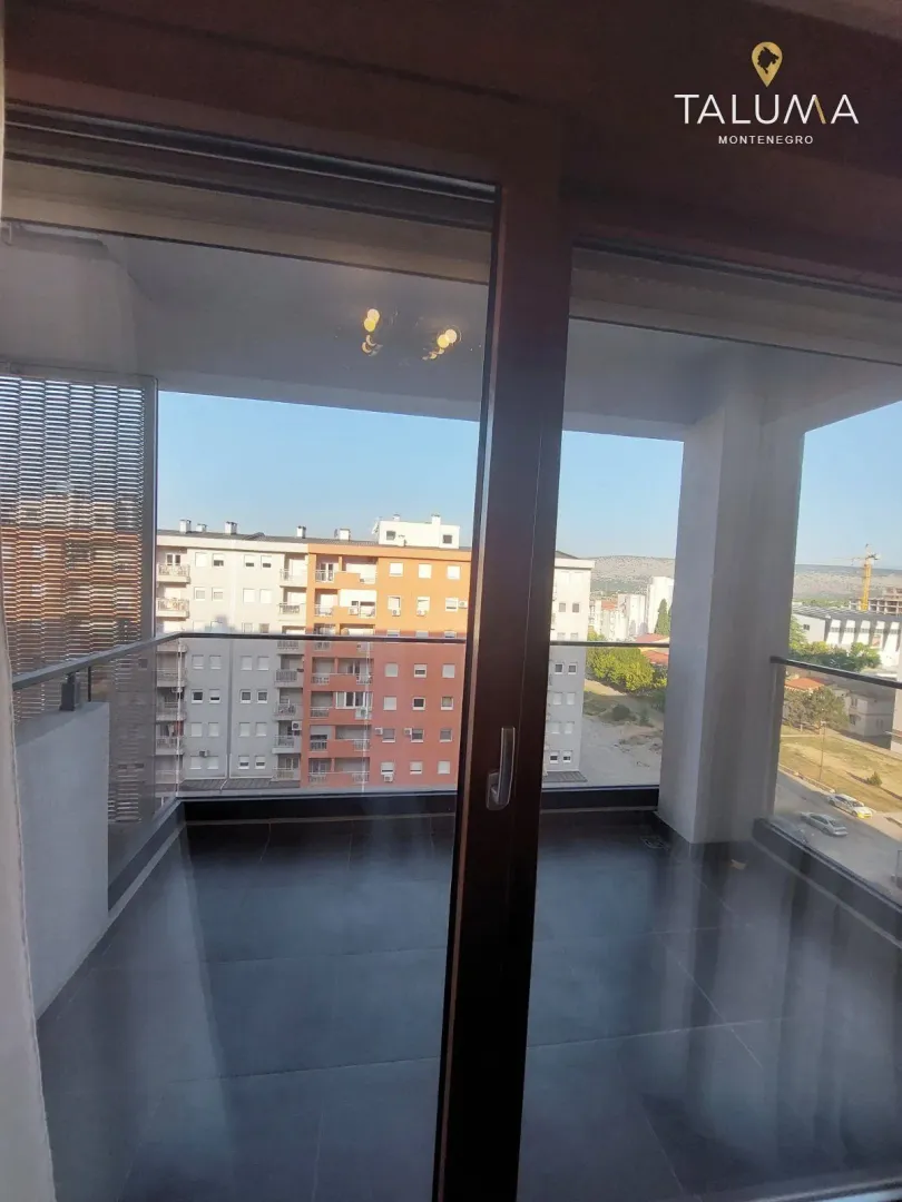 View from the balcony overlooking surrounding buildings and cityscape.