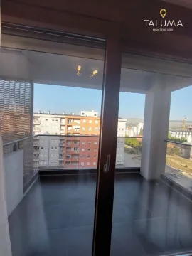 View from the balcony overlooking surrounding buildings and cityscape. - image 9
