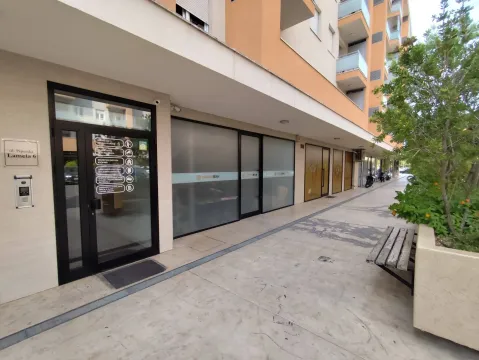 Entrance to a residential building with commercial spaces on the ground floor. - image 4