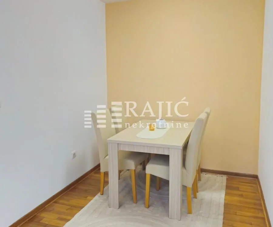 Dining area with a table and four chairs.