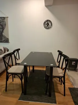 Dining table with chairs in the living room. - image 4