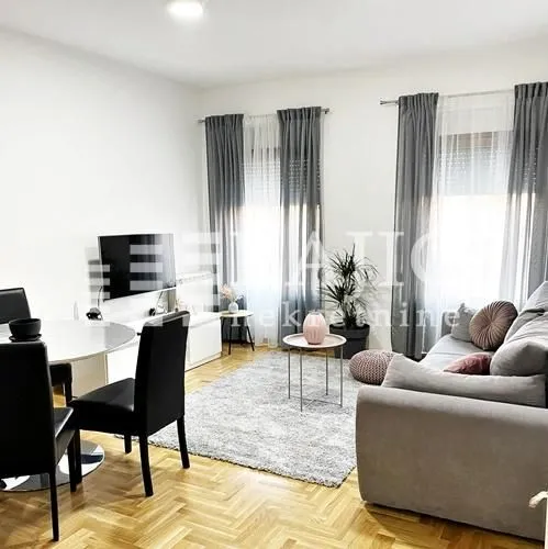 Bright living room with sofa set and dining table.