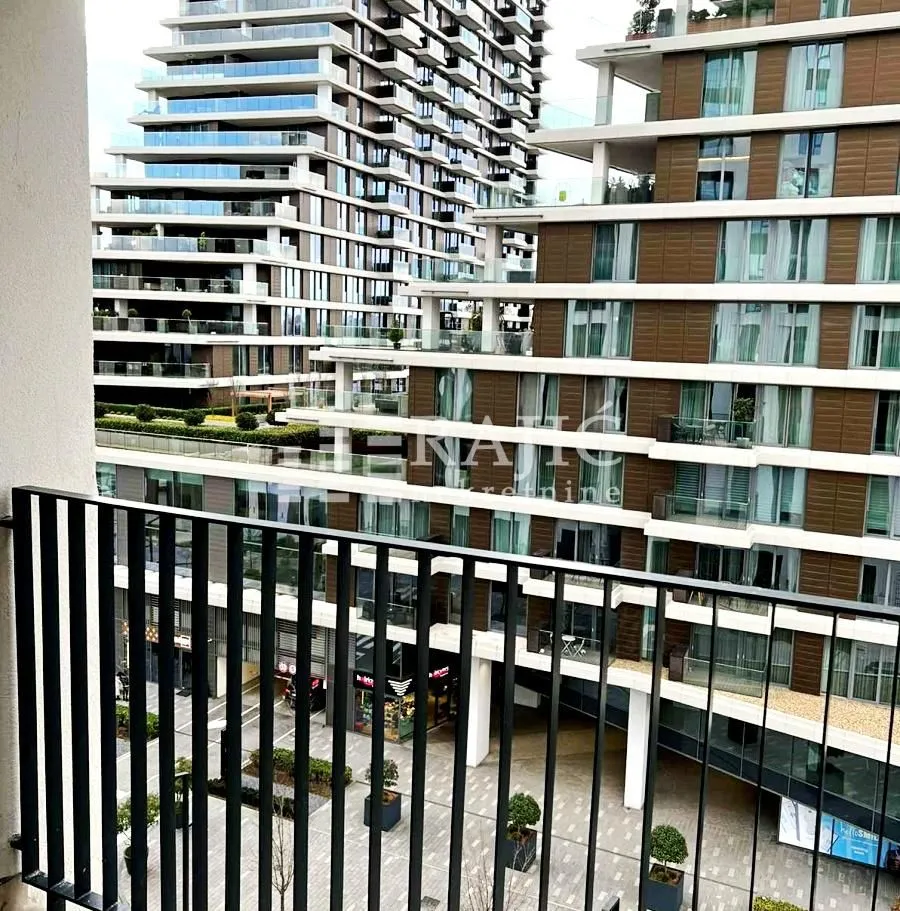 View from the balcony overlooking modern residential buildings and courtyard.