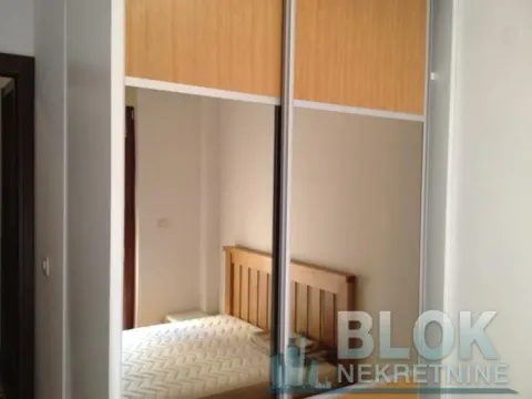 View of the bedroom with a wardrobe and bed in the mirror. - image 6