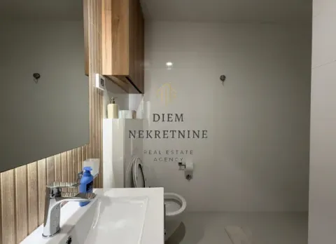 Modernly equipped bathroom with a washbasin and a toilet. - image 13