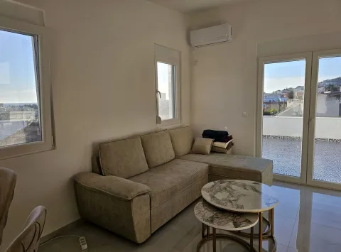 Living room with a sectional sofa, coffee table, and access to the terrace. - image 3