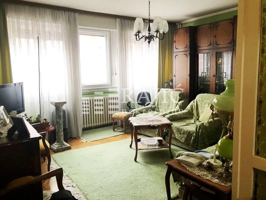Living room with a sofa set and traditional furniture.