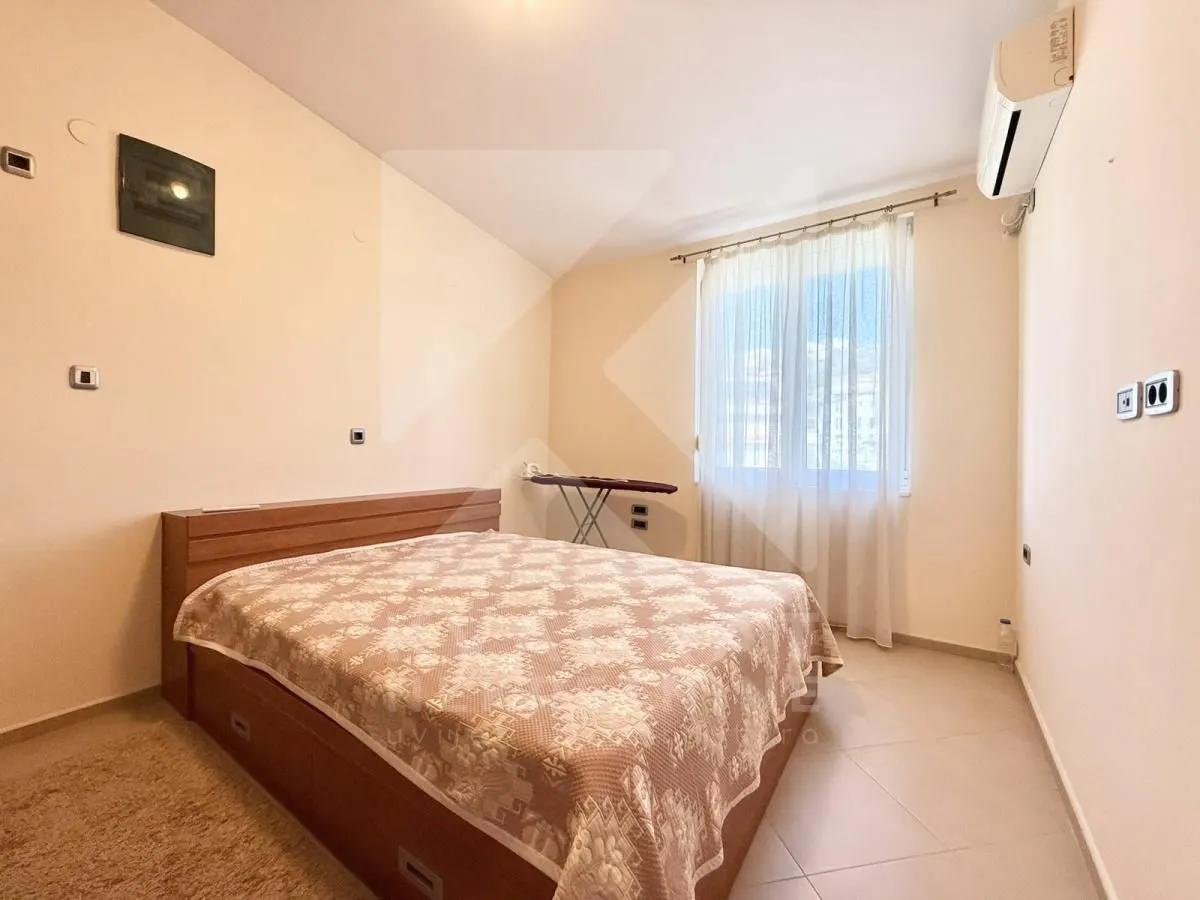 Bedroom with a double bed and a window.
