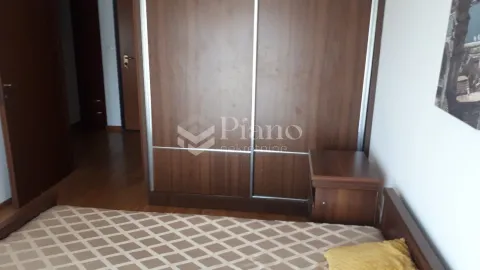 Bedroom with a large wooden wardrobe and bed. - image 12
