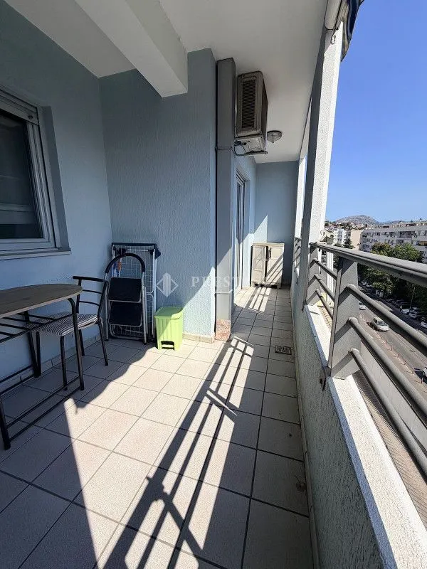 Spacious balcony with seating furniture and a view of the surroundings.