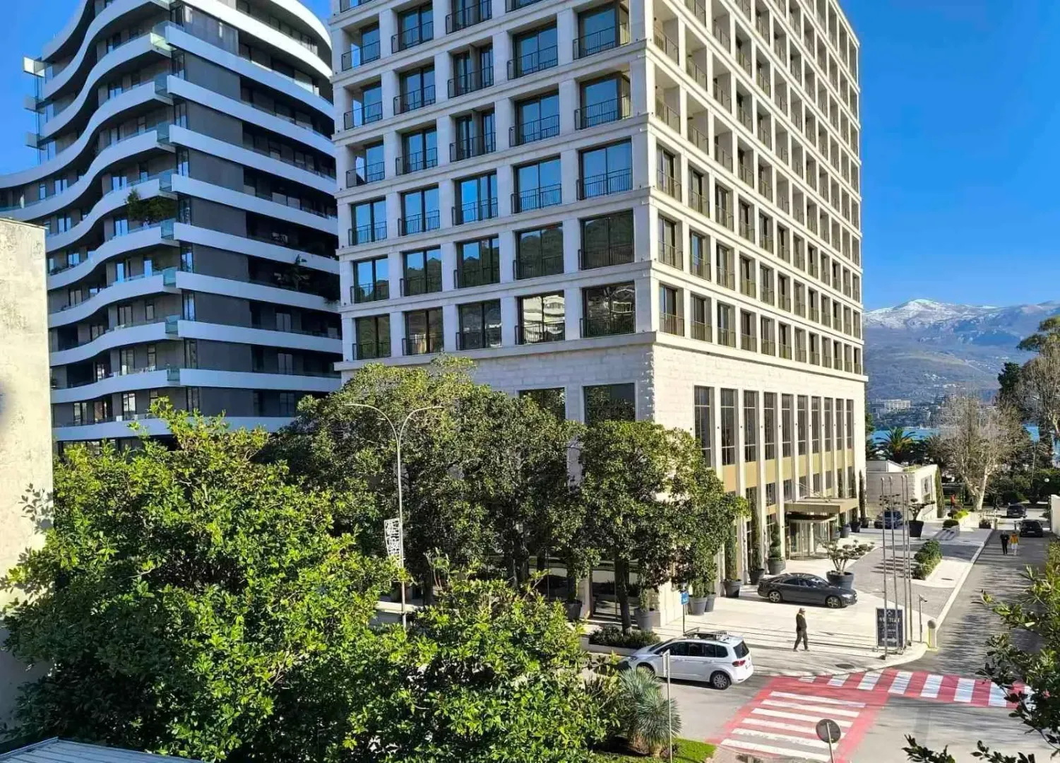 Exterior view of a modern multi-story building surrounded by greenery.