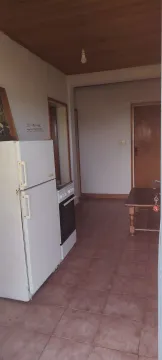 Smaller kitchen with a refrigerator and stove within the room. - image 3