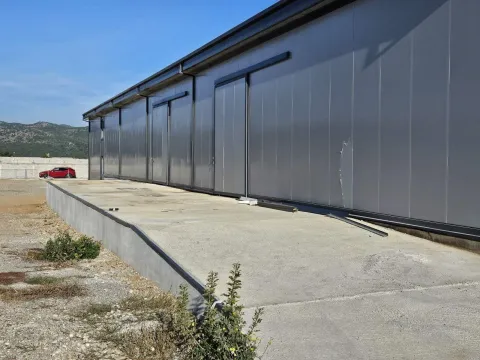 Exterior of an industrial building with a concrete ramp. - image 2