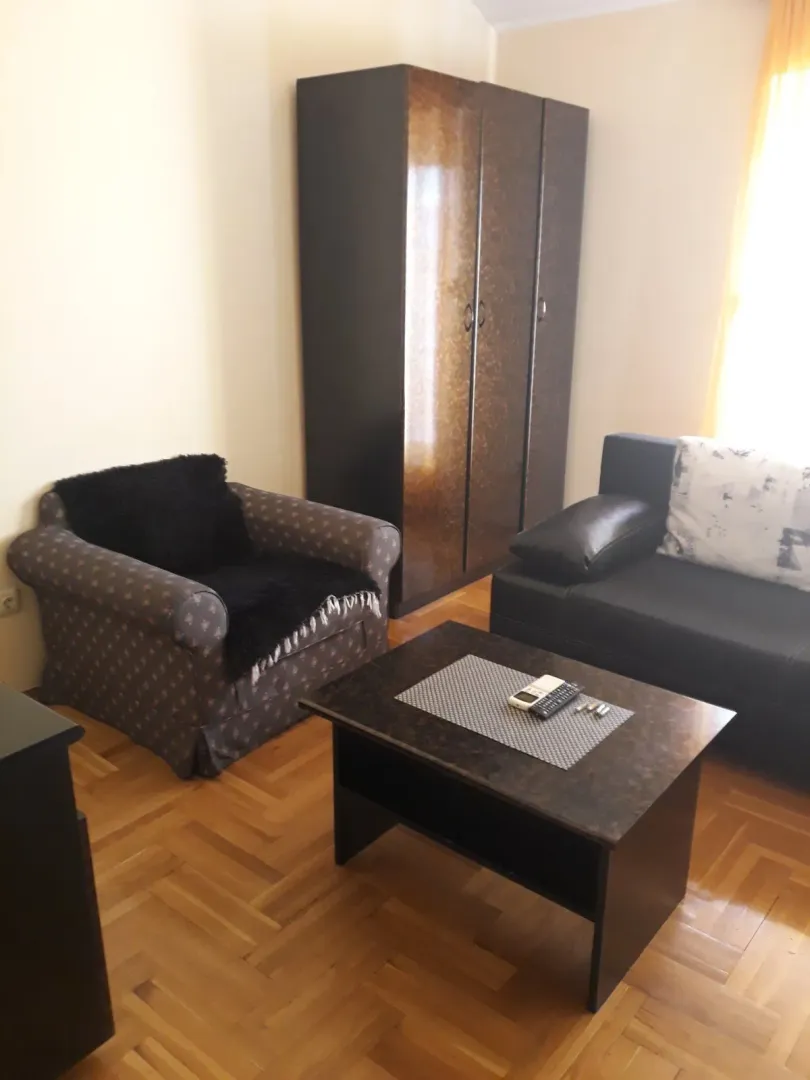 Living room with a sofa, armchair, and coffee table.