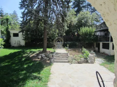 Yard of the house with paved pathway, lawn and greenery. - image 17