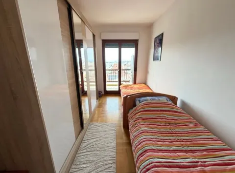 Small bedroom with two beds and a built-in wardrobe. - image 7