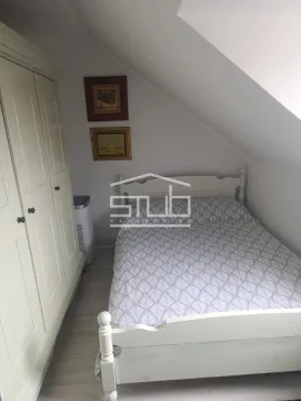 Small bedroom with a double bed and wardrobe under a sloping ceiling. - image 6