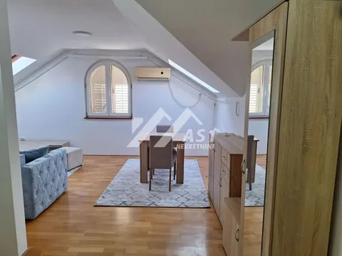 Attic space with a living room, dining area, and hardwood flooring. - image 8
