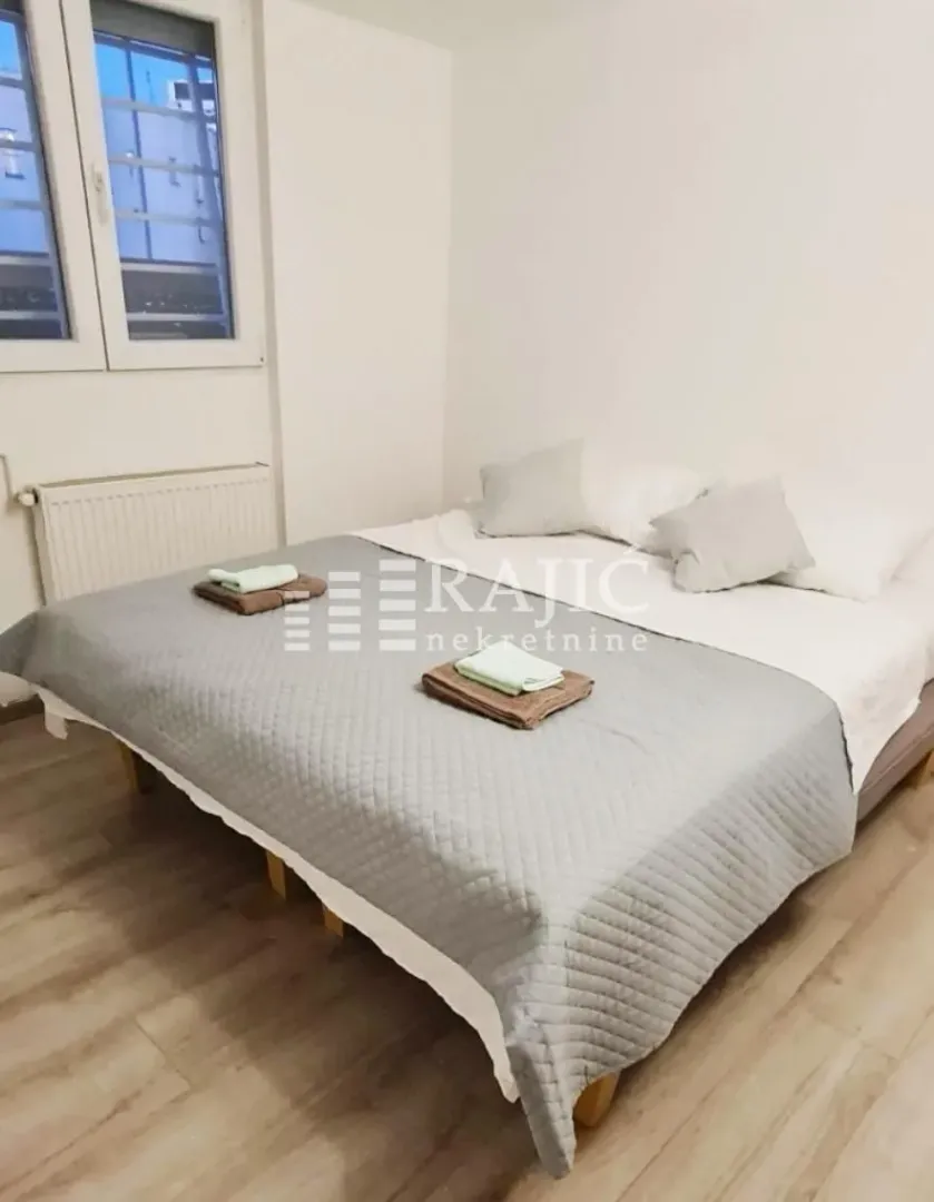 Bedroom with a large double bed and a window.