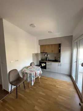 Smaller kitchen with a dining table and chairs. - image 2