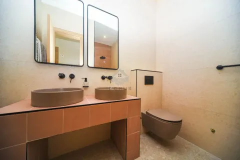 Modern bathroom with two washbasins, mirrors, and a wall-mounted toilet. - image 24