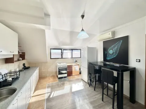Kitchen with a dining table and chairs in the attic. - image 3