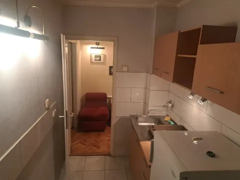 Smaller kitchen with a sink, cabinets, and a refrigerator. - image 8