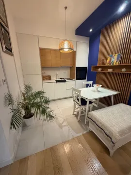 Modern kitchen with dining area and built-in appliances. - image 4