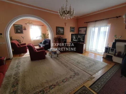 Spacious living room with seating set and rugs. - image 7
