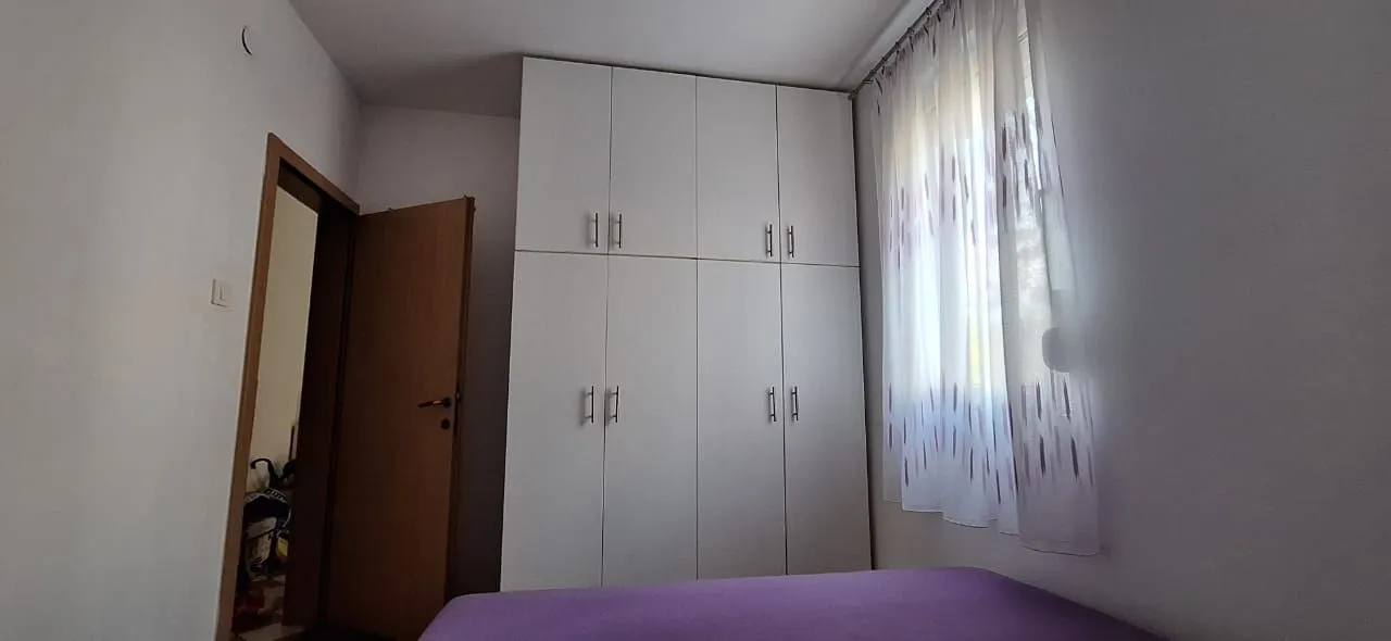 Bedroom with a large fitted wardrobe and a bed.