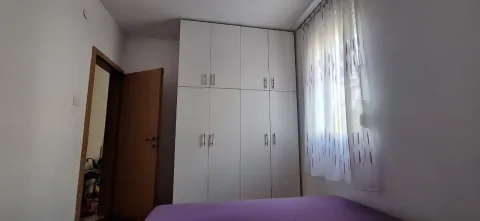Bedroom with a large fitted wardrobe and a bed. - image 8