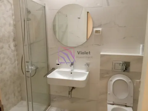 Modern bathroom with a walk-in shower, washbasin, and wall-hung toilet. - image 9