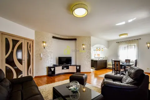 Spacious living room with sofa set, TV, and dining area in the background. - image 3