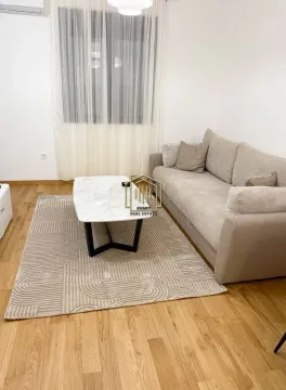 Living room with a comfortable sofa and a coffee table. - image 5