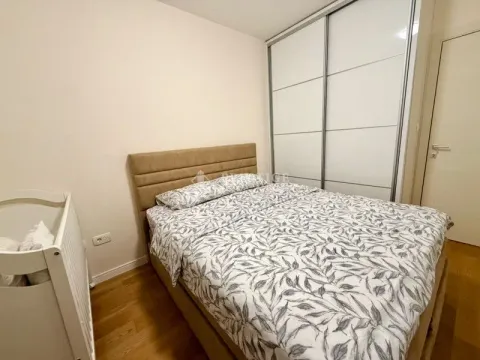 Bedroom with a double bed, wardrobe, and baby crib. - image 9