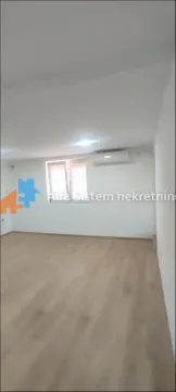 Empty bright room with laminate flooring, white walls, and an air conditioning unit. - image 8