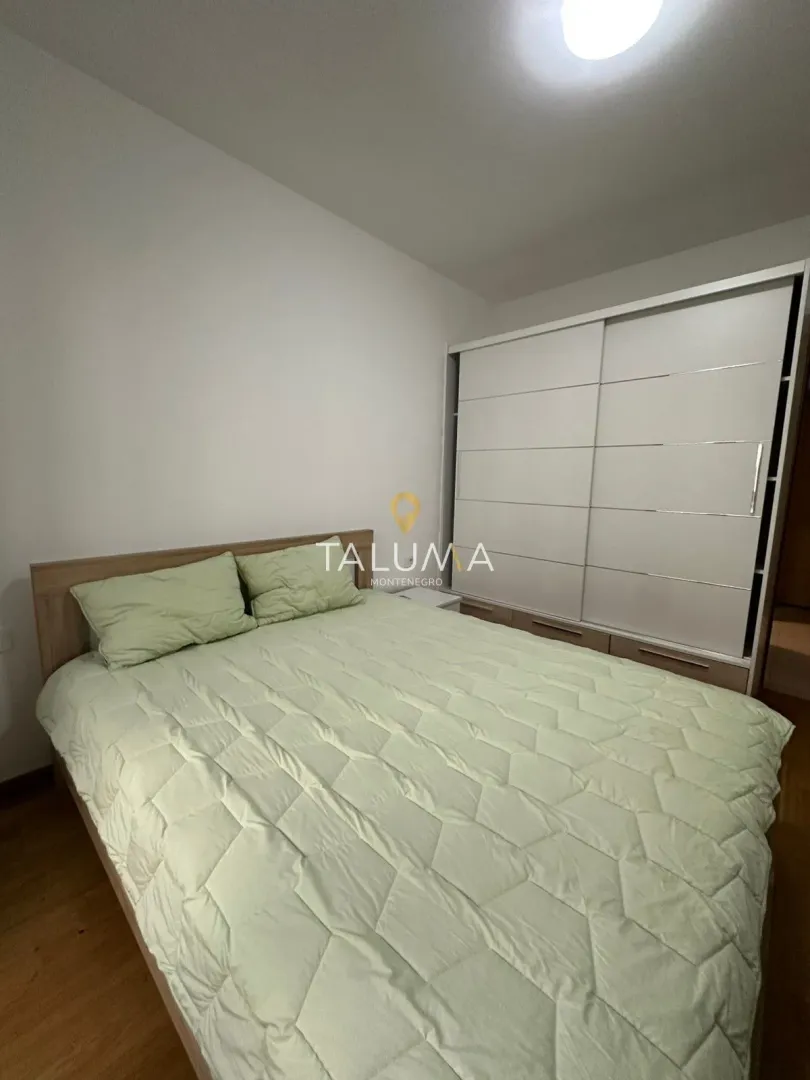 Bedroom with a double bed and a large built-in wardrobe.