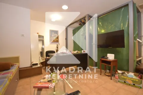Living room with a desk and a television. - image 4
