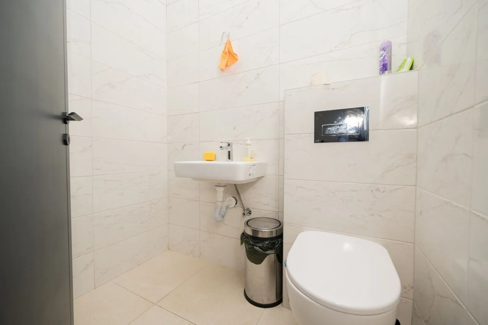 A small and functional bathroom with a toilet and sink.
