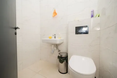 A small and functional bathroom with a toilet and sink. - image 8