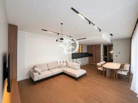 Spacious living room with a sofa set, dining area, and kitchen in the background. - image 2